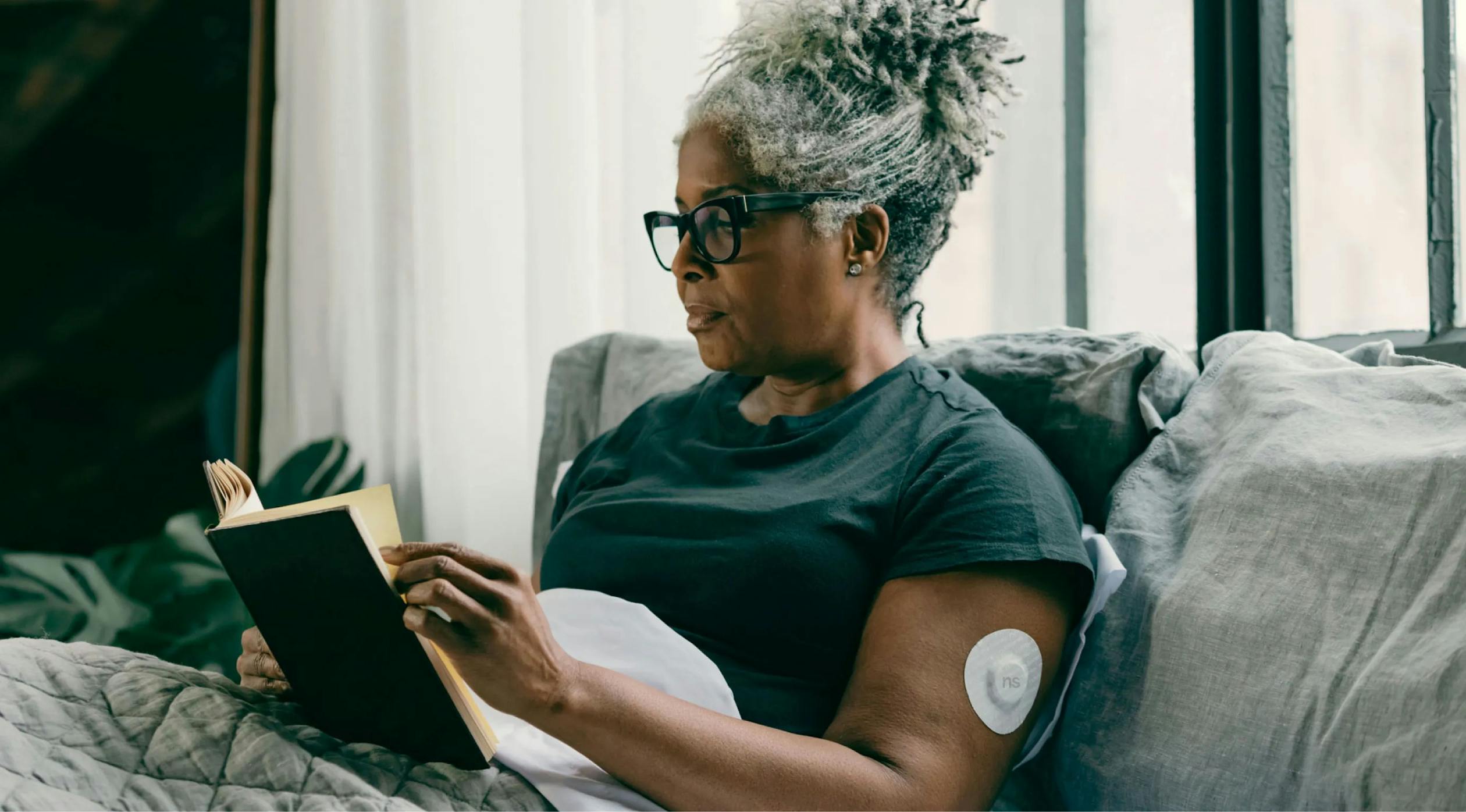 Person checking blood glucose reading with CGM or glucometer
