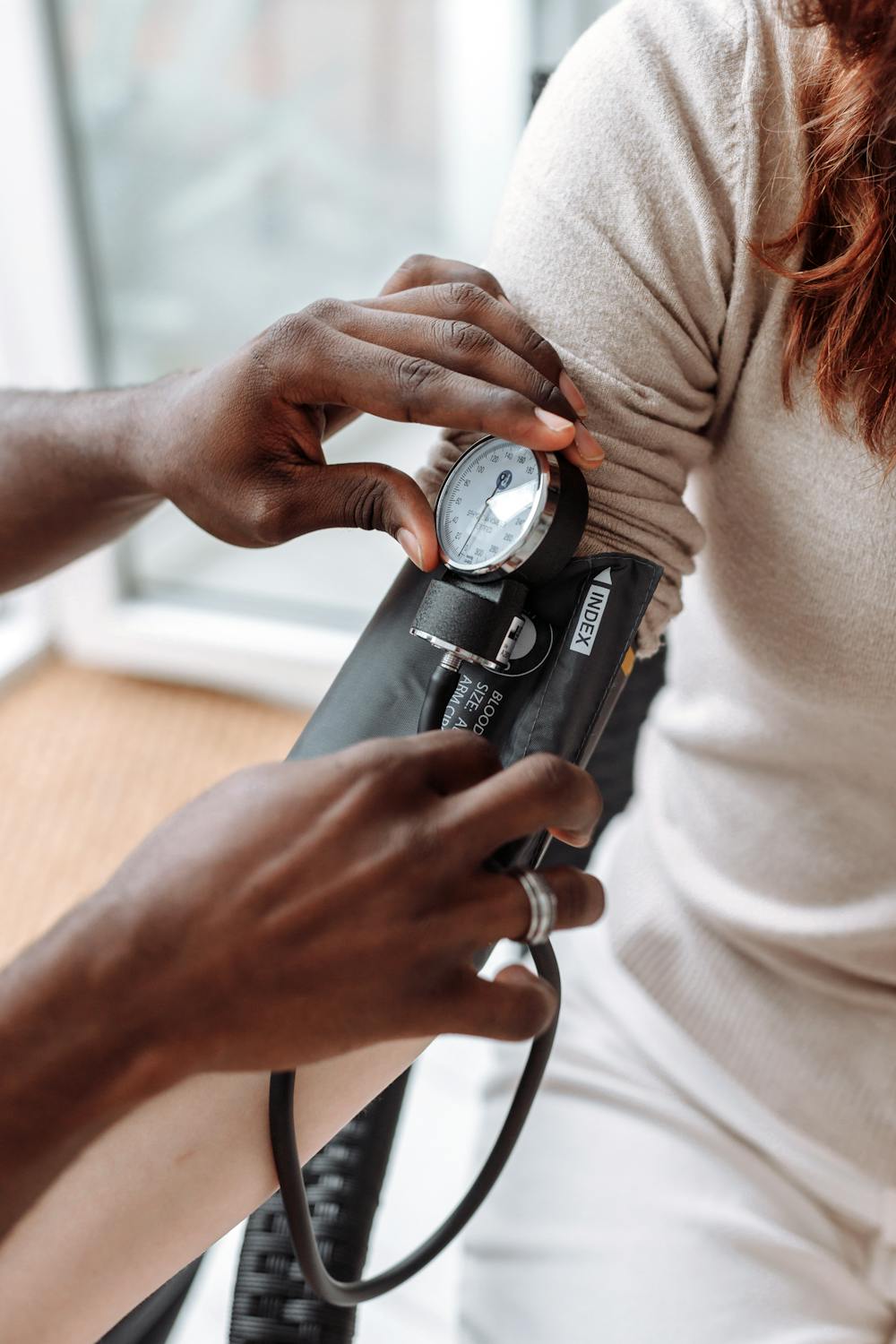 Person measuring blood pressure with iPhone nearby