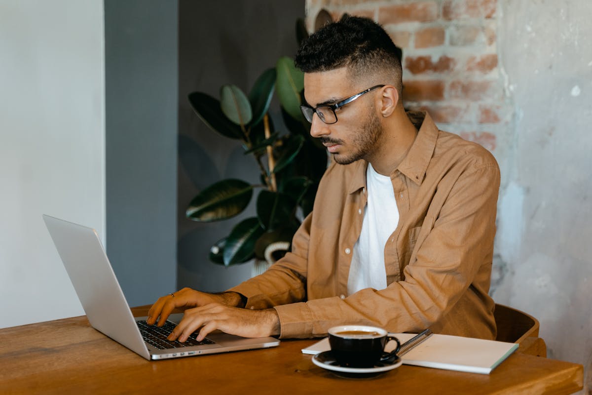 Developer working with code on laptop
